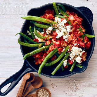 Ketogenes Pfannengericht mit grünen Bohnen, Tomaten und Feta in gusseiserner Pfanne